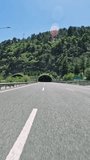 Car navigates dark road tunnel, capturing tunnel driving experience. Video from car perspective, highlighting journey in tunnel. Focus on movement through tunnel.