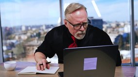 Concerned Caucasian businessman looks at laptop screen. Man looks worried, having trouble with computer. Blurred backdrop. - Powered by Shutterstock - Get 15% off with code: PIKWIZARD15
