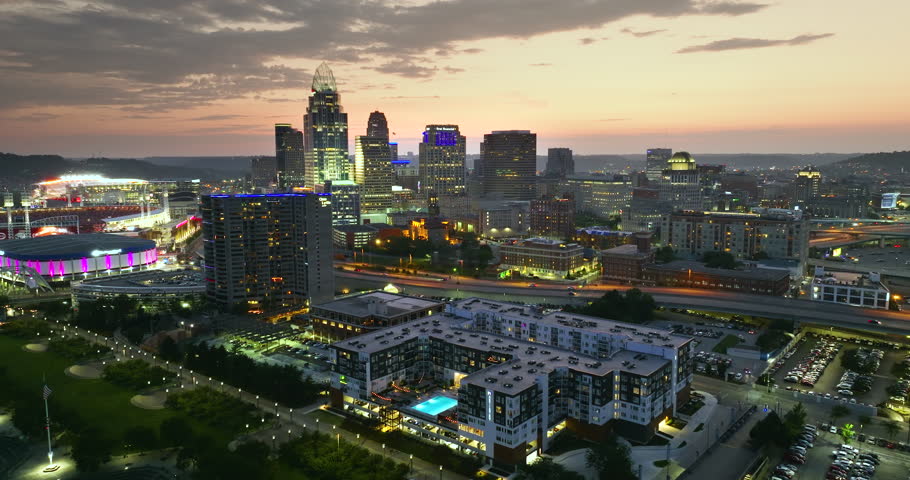 Cincinnati Ohio urban architecture in city downtown at night. Panoramic view of business district skyline with high-rise buildings at nightfall.