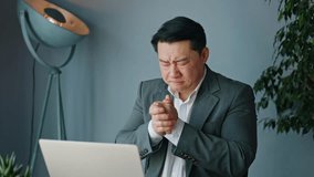 Nervous chinese man dressed in elegant office attire waving with hands and making fan because feeling hot in office environment. Confused male having temperature indoors. Concept of emotions. - Powered by Shutterstock - Get 15% off with code: PIKWIZARD15