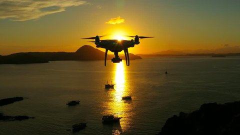 Drone pilot with high resolution camera flying over padar island in Komodo, Indonesia.