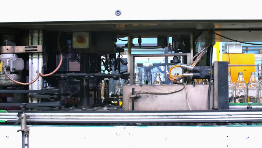 Glass factory, production of glass containers. Packaging of food containers. Robotics in industry. Modern technologies, robotic machines produce products. Technological work at the plant.