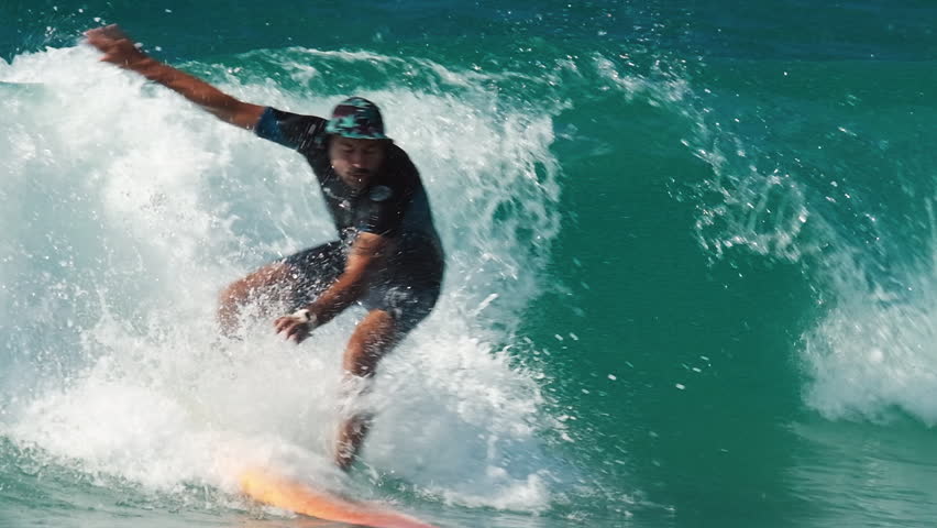 Beginner surfer rides the wave and falls