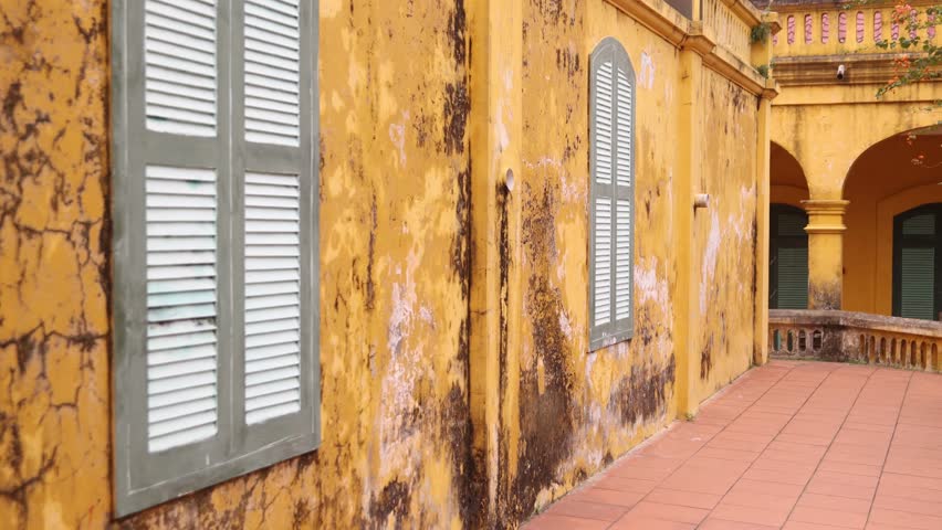 grungy old yellow walls in the citadel in old quarter Hanoi the capital city of Vietnam in Southeast Asia