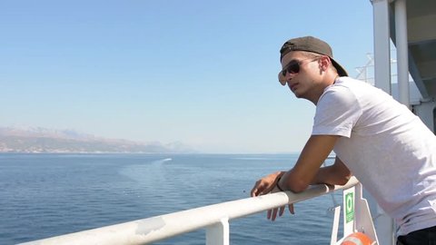 Young boy travels by ferry to the Adriatic sea in the summer