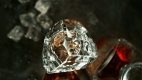 Super Slow Motion of Falling Ice Cube into Whiskey. Filmed on High Speed Cinema Camera, 1000 fps, Camera Tracking the Target. - Powered by Shutterstock - Get 15% off with code: PIKWIZARD15