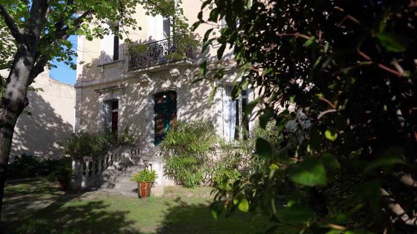 Slow establishing shot of a stone staircase leading to a villa in Pignan