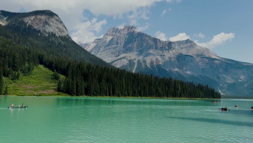 Emerald Lake is located in Yoho National Park in Canada. Famous for its emerald color and the splendid view of the Canadian Rockies that frame it. Canoe excursion with family. Trekking to the lake.
