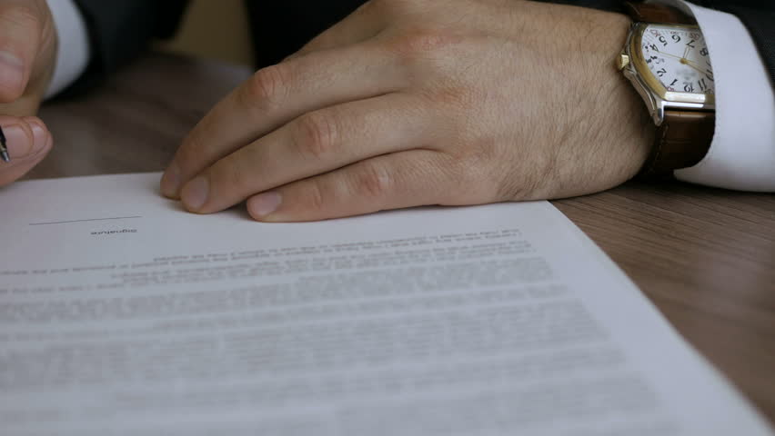  The man corrects and fills the document. Businessman signing business contract agreement, close up of male hand with pen writing signature. Royalty-Free Stock Footage #34993492