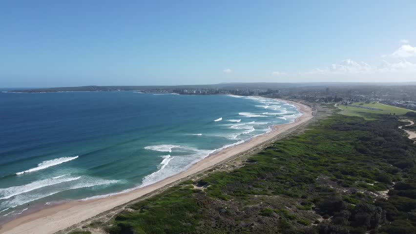 Ascending panoramic aerial shot of the famous Cronulla beach and coastline on a clear and fair day