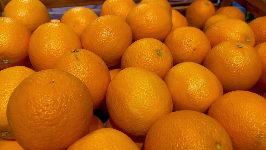 a lot of fruits. market. store. background. citruses. healthy food. natural. food. health. Vegeterian. diet. Orange fruit on a wooden bucket. Top view