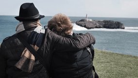 Aged couple hugging each other and watching the view - Powered by Shutterstock - Get 15% off with code: PIKWIZARD15