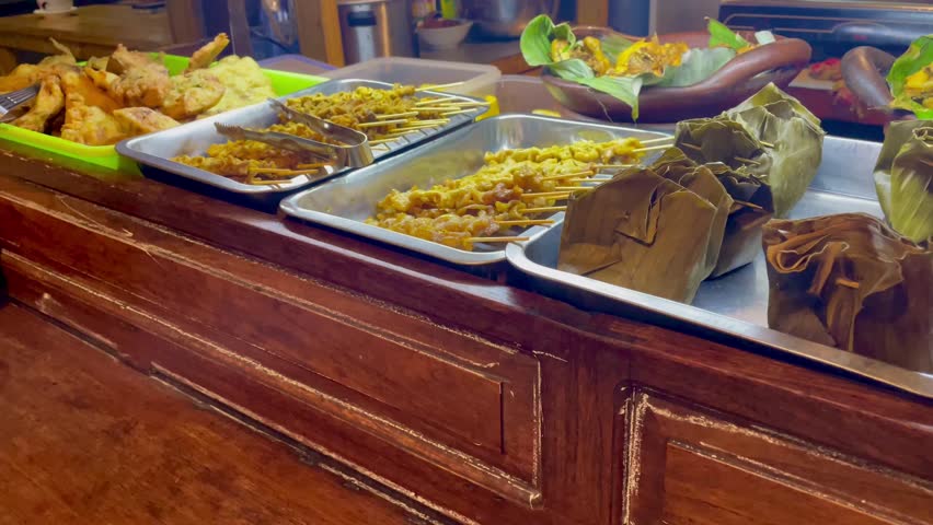 Nasi angkringan or nasi kucing traditional food from central java Indonesia. Nasi kucing with egg satay and chicken skin