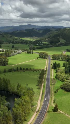 Road in a rural area of Waikato aerial drone view. North Island, New Zealand. Vertical video shot