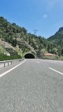 Car navigates through dark road tunnel on highway, showcasing highway driving. Video highlights experience from highway perspective, emphasizing highway travel dynamics