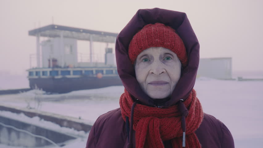 Aged female tourist traveling North Pole. Petrol station in Arctic. Woman with green eyes sending regards from Antarctic circle. Oil and gas industry base worker. Extreme cold. Petroleum technician. 