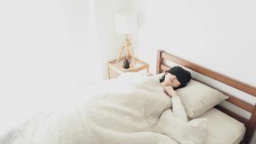 A woman sleeping with an eye mask in a bright room - Powered by Shutterstock - Get 15% off with code: PIKWIZARD15