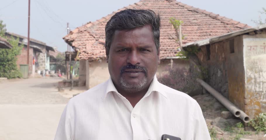 Bhandardara, Maharashtra, India,January 7th 2024 -   Indian middle age man smiling towards camera at village.