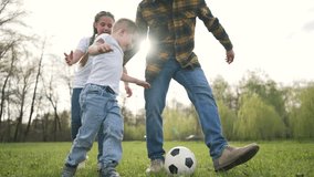 Father and children having fun playing soccer. Family dribbling ball together outdoors. Joyful playtime on grass in park. Active bonding time outside. Soccer game with ball for family fun outdoors. - Powered by Shutterstock - Get 15% off with code: PIKWIZARD15