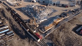 Industrial scrapyard in hamilton, ontario, with excavator and train, aerial view - Powered by Shutterstock - Get 15% off with code: PIKWIZARD15