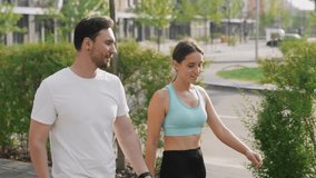 A couple spend leisure outdoors, walks and steps in unison with pet, a Jack Russell Terrier dog, on a warm summer day in the city park area. The concept of friendship and companionship between animal - Powered by Shutterstock - Get 15% off with code: PIKWIZARD15
