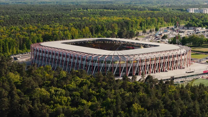Football stadium in Bialystok. The stadium where the Jagiellonia team plays matches. Aerial footage in the rays of the spring sun.