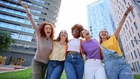 Multirracial cheerful young only women celebrating together. Excited cheerful female group looking at camera with skyscrapers at background having fun and laughing. Social gathering of diversity - Powered by Shutterstock - Get 15% off with code: PIKWIZARD15