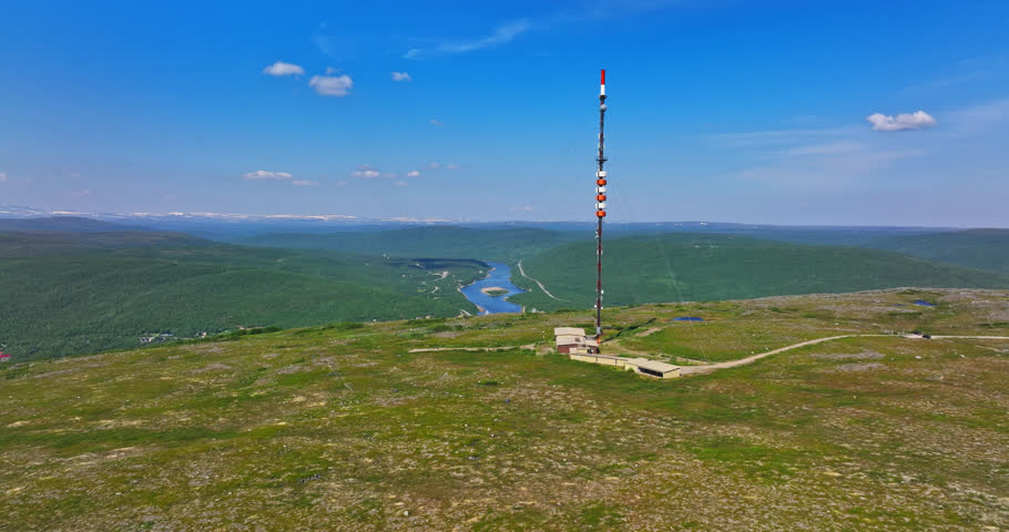 Aerial ascending shot a radio tower on top of a fell in Utsjoki, Finland
