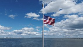 American flag waving in the wind in front of Atlantic Ocean 
