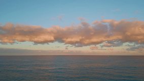 Aerial tranquil ocean sunset painting clouds pink. Peaceful horizon glowing in orange and pastel hues. Evening sky reflecting serene end of day. Reflective water mirroring seascape beauty at dusk. - Powered by Shutterstock - Get 15% off with code: PIKWIZARD15