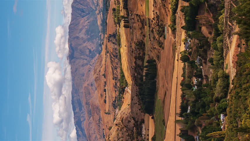 Vertical video of cloud shadows moving across New Zealand landscape, timelapse.