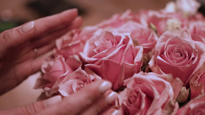 Florist Crafting Bouquet. Florist's Bouquet Design. Florist at Work. Florist's Creative Process. Florist makes bouquet in flower shop. Florist making bouquet of flowers in flower shop