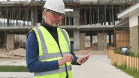 Mature age engineer using phone typing message, foreman at construction site looks blueprint for building project in screen smartphone.  - Powered by Shutterstock - Get 15% off with code: PIKWIZARD15