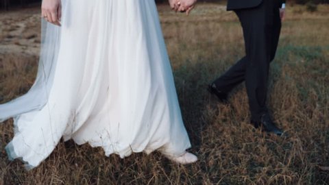 Bride and groom. Couple walking in the forest. Foot view. Wedding in the forest. slow motion Stockvideó