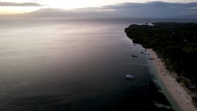 4K Aerial Drone video of beautiful sunset spot, Paliton beach at golden hour with people watching sunset, Siquijor island, Philippines