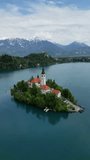 Aerial view of Bled lake with the Pilgrimage Church of the Assumption of Maria on a small island, Slovenia. Vertical video 4k