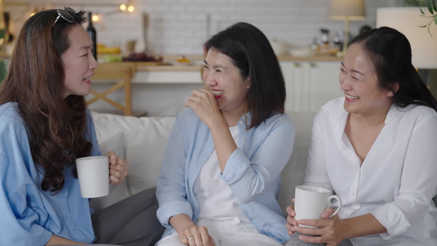 Asian middle aged woman chatting while drinking coffee and tea. friendship concept