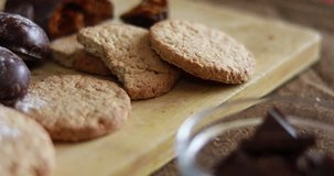 Crispy and chocolate chip cookies on the table, close-up, slide movement, 4k 2160p video