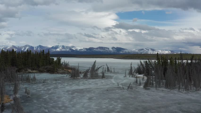 Drone shot of thawing Sulphur Creek flowing into frozen Sulphur Lake in Kluane as seen from the Alaska Highway at km 1614 in spring.