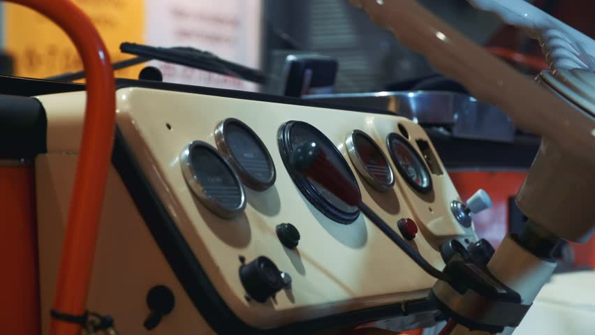 Vintage vehicle's dashboard with retro dials and steering wheel, old car interior Royalty-Free Stock Footage #3500782519