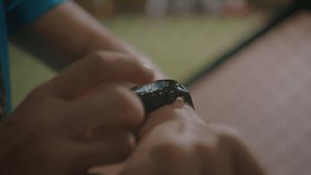 Close-up of a man who turns on a stopwatch using his smart watch before an evening jog - Powered by Shutterstock - Get 15% off with code: PIKWIZARD15