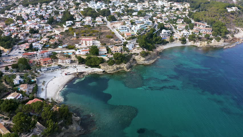 Aerial view of the little beach of Cala Fustera, Cala Llobella, Cala del Advocat in Benissa coast, Mediterranean Sea, Spain.