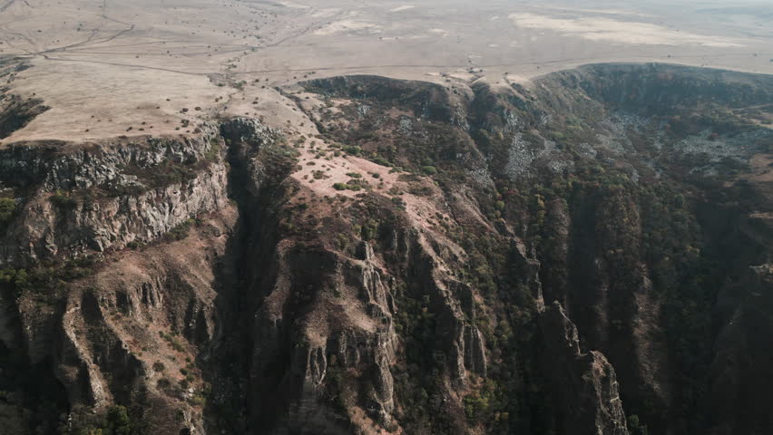 Canyon near the historical Armenian city of Garni. The quadcopter flies over the canyon and captures the flat top of the canyon as well as a sharp descent down