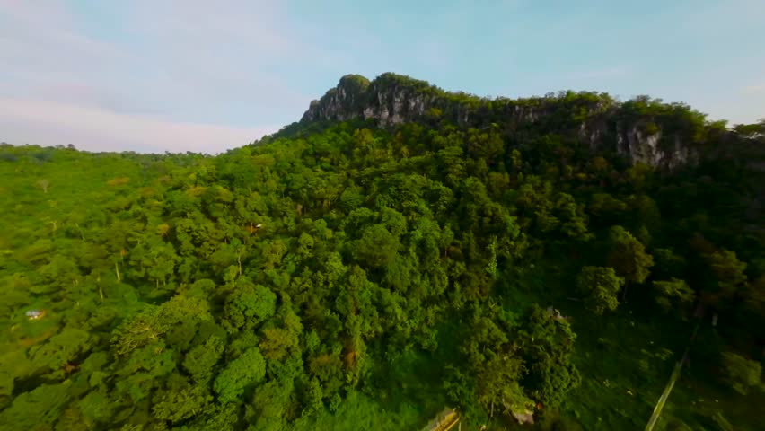 An aerial FPV view peak of rocky hills Bukit tabur during morning. Royalty-Free Stock Footage #3500895783