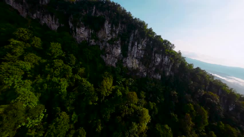 An aerial FPV view peak of rocky hills Bukit tabur during morning. Royalty-Free Stock Footage #3500896867