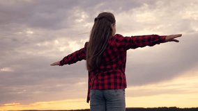 happy child in fresh air is enjoying freedom.child dreams of becoming an airplane pilot.child flies with outstretched arms.Silhouette of child at sunset. girl is happy, flies for dream. Hands to side. - Powered by Shutterstock - Get 15% off with code: PIKWIZARD15