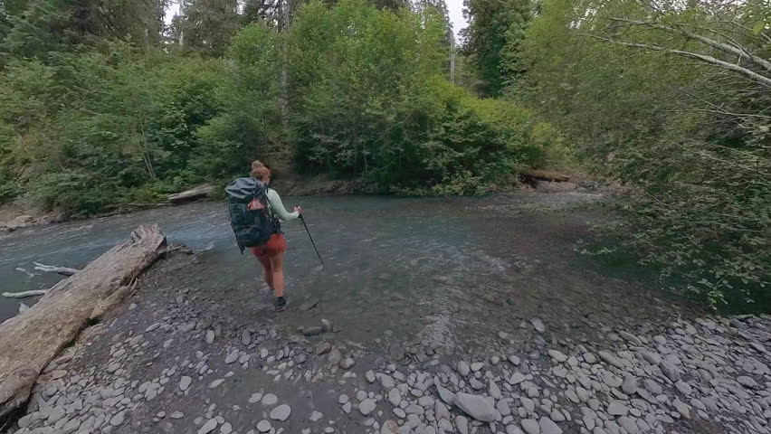 Woman Crosses Creek in Olympic National Park