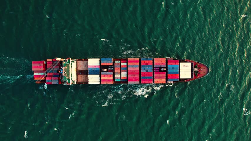 Aerial view of a large cargo container ship sailing on the sea or ocean for logistics import export, shipping or transportation.