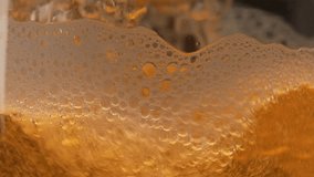 Light beer is poured into a glass close-up. Beer bubbles and foam splash in the mug. Refreshing amber beer drink in slow motion - Powered by Shutterstock - Get 15% off with code: PIKWIZARD15