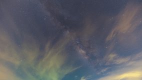 Time lapse Milky Way on a cloudy night. The long night saw the Milky Way begin to perpendicular to the sky. Clouds followed by, obscuring the sky and stars. The night sky sparkles with stars.

 - Powered by Shutterstock - Get 15% off with code: PIKWIZARD15